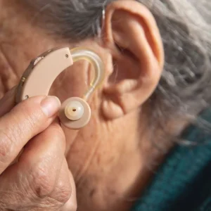 caucasian-elderly-woman-with-hearing-aid-ear-1-1365x2048.jpg